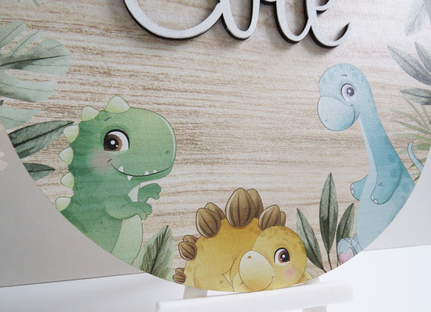 A custom name kids sign with a cute dinosaur printed design.