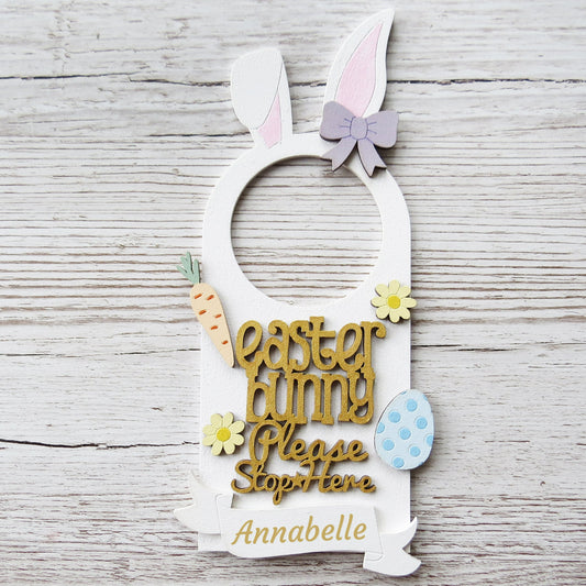 A custom name wooden pastel painted door hanger saying Easter bunny please stop here.