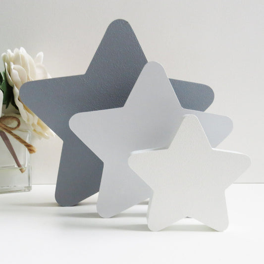 Painted grey freestanding star blocks for a childrens nursery.
