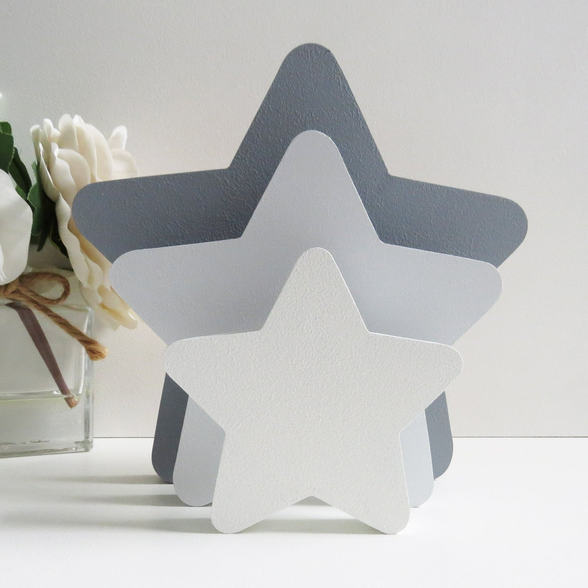 Painted grey freestanding star blocks for a childrens nursery.