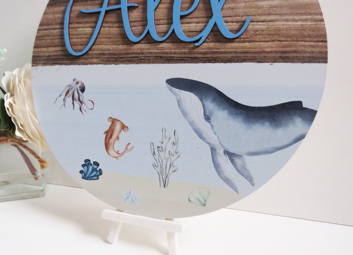 A printed plaque with an under the sea whale printed design. Perfect for any nursery or kids bedroom decor.