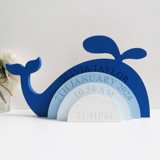 Engraved whale design rainbow stacker painted in shades of blue.