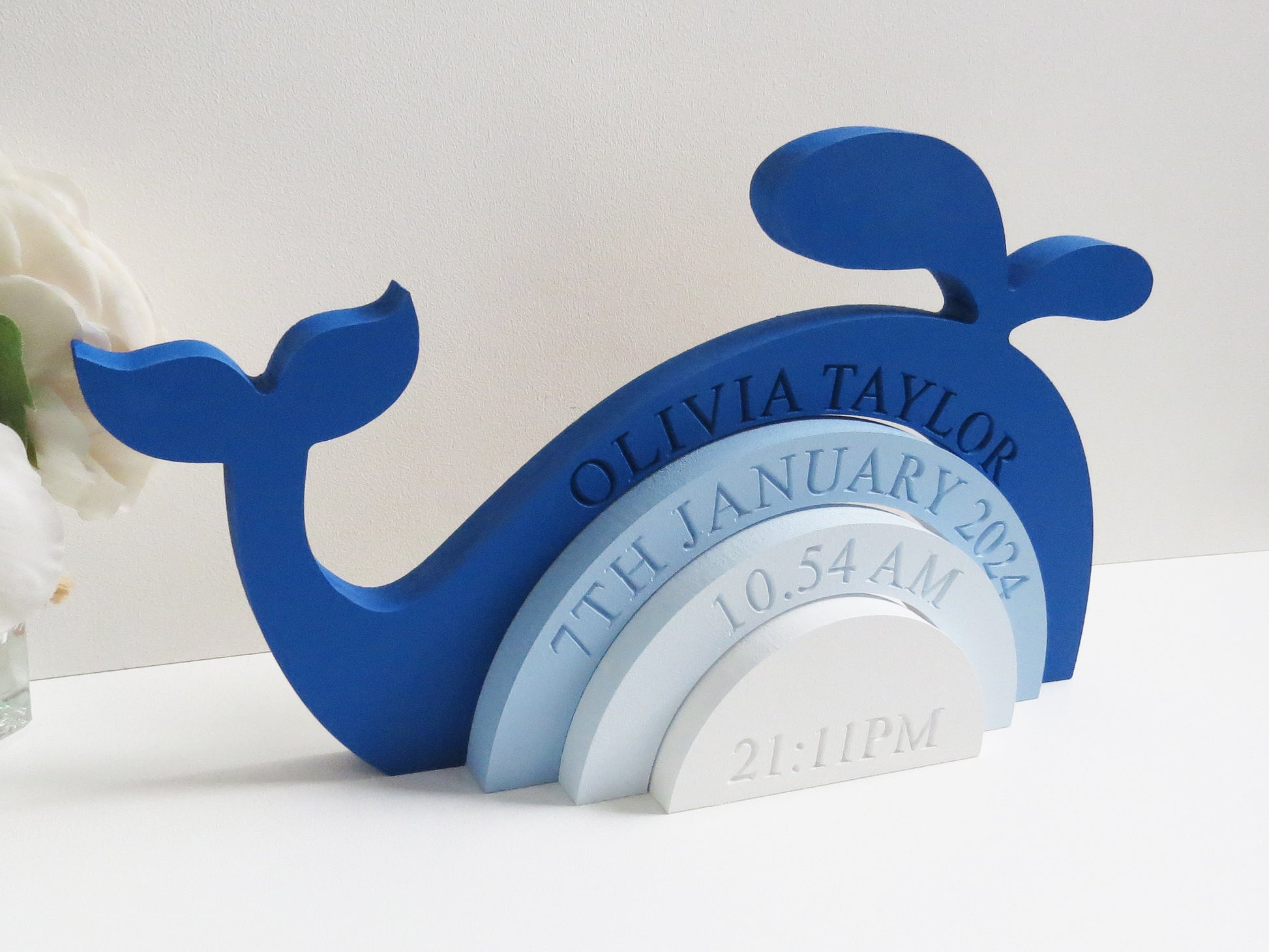 Engraved whale design rainbow stacker painted in shades of blue.