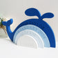 Engraved whale design rainbow stacker painted in shades of blue.