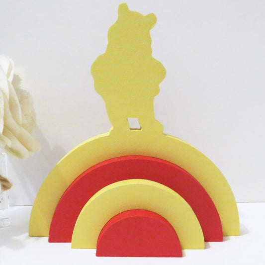 Winnie the pooh designed rainbow stacker painted red and yellow.