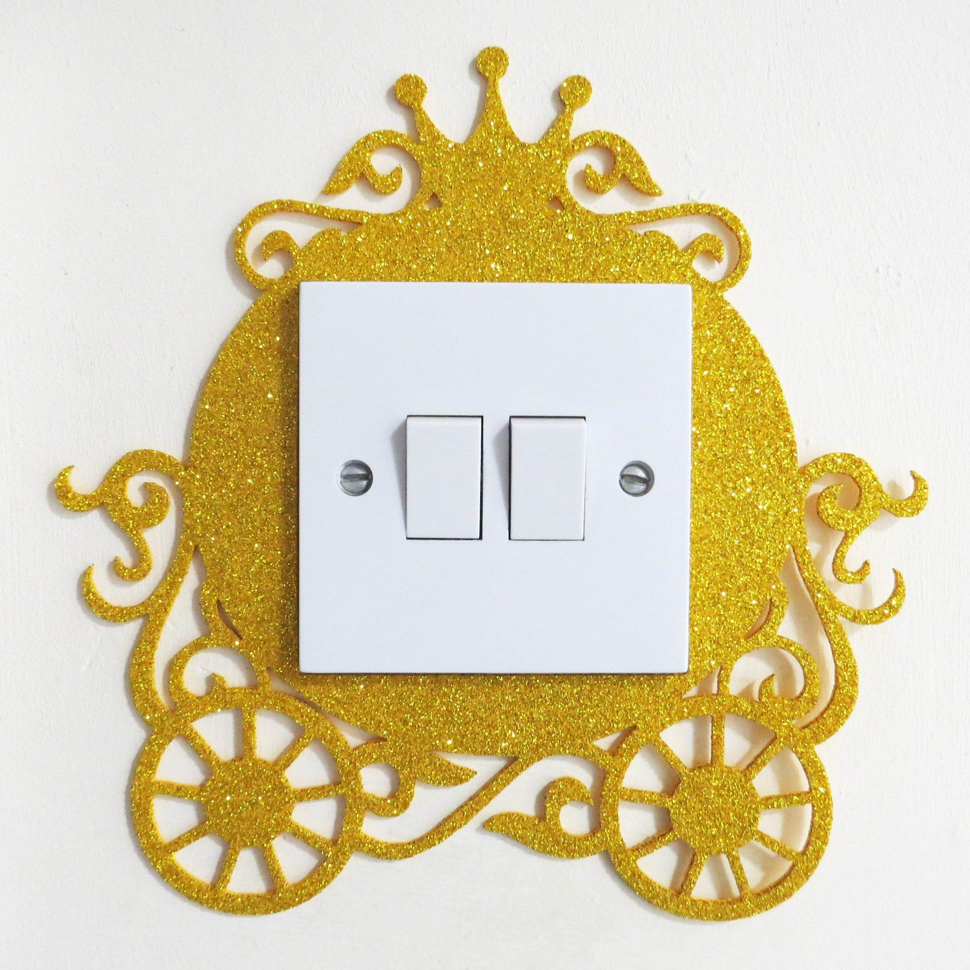 Gold glitter princess carriage shaped light switch surround.