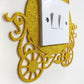 Gold glitter princess carriage shaped light switch surround.