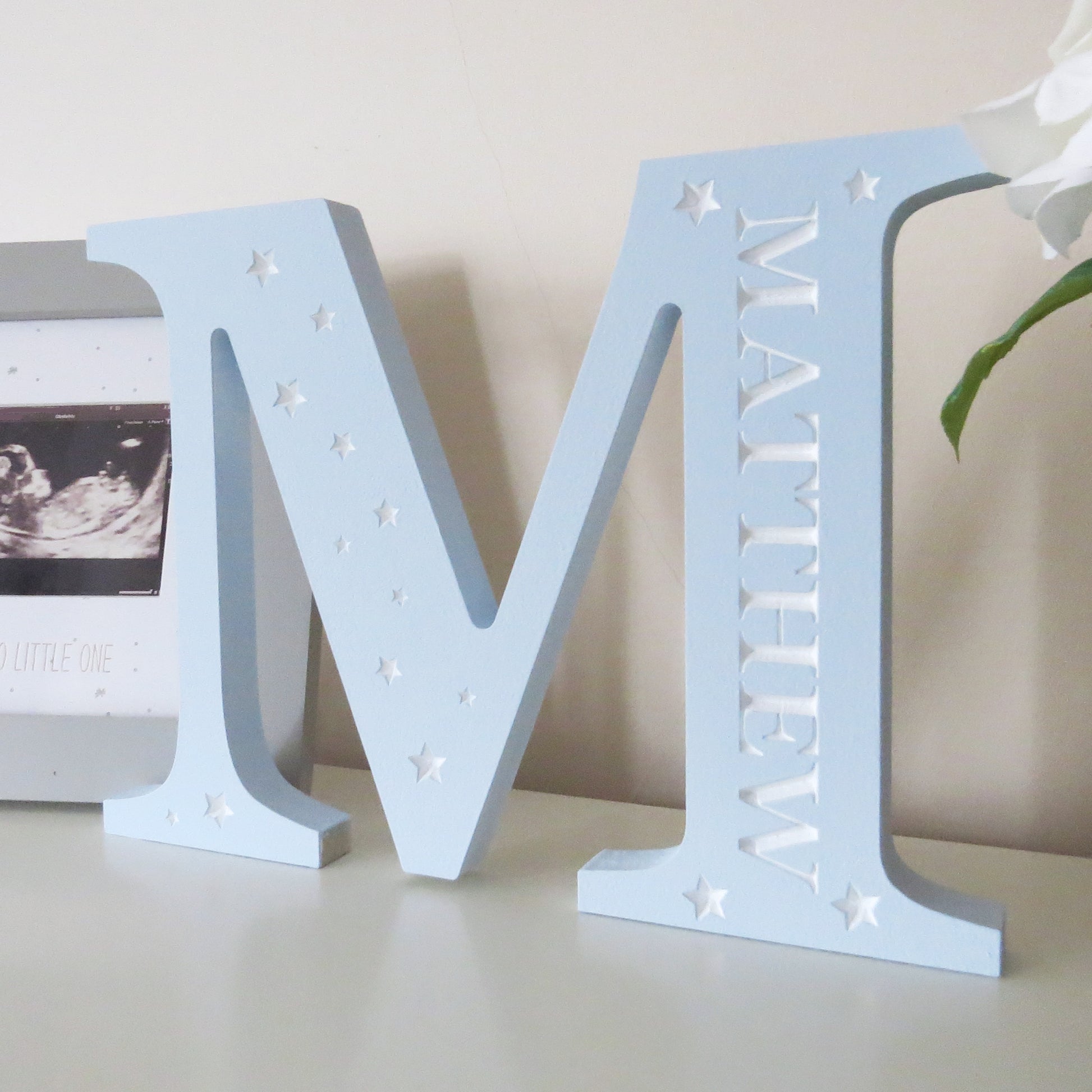 Childrens nursery freestanding letter with engraved name and stars.