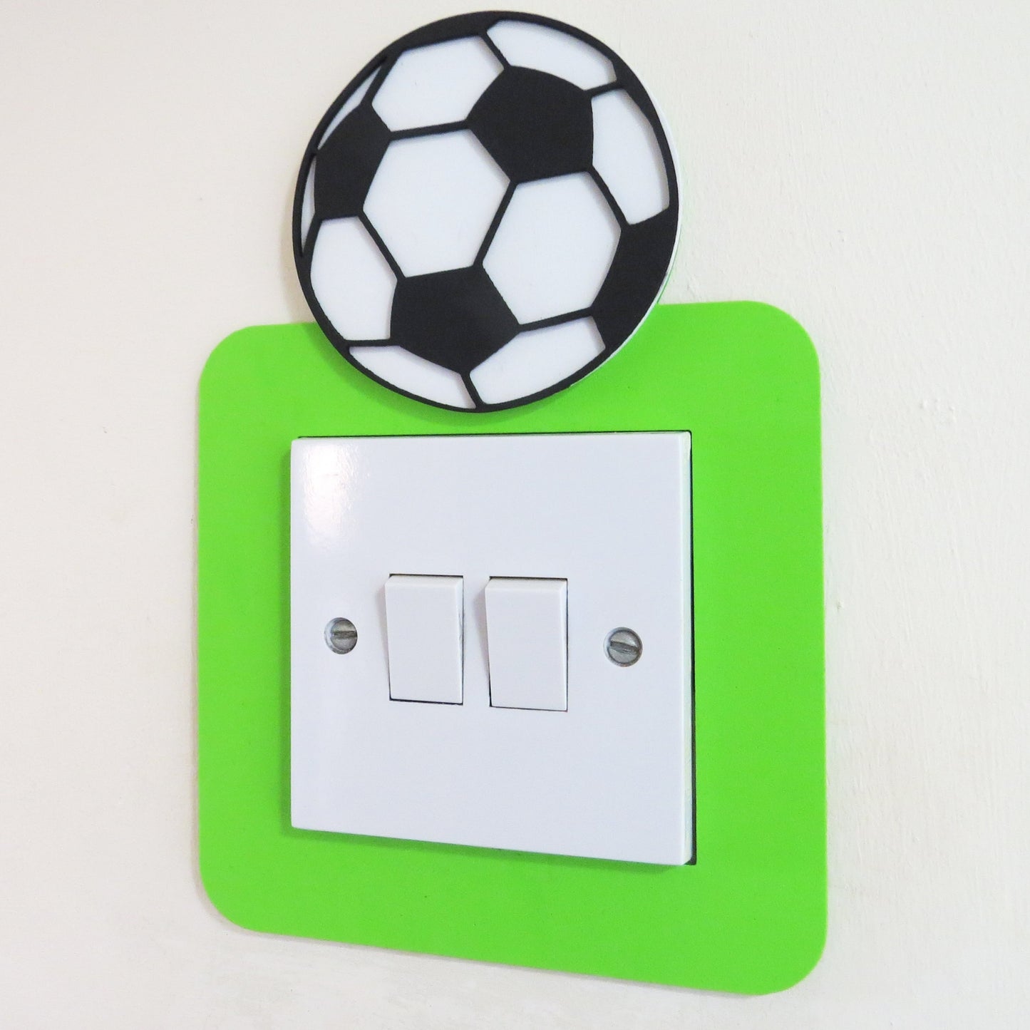 Green craft foam light switch surround designed with a black and white football