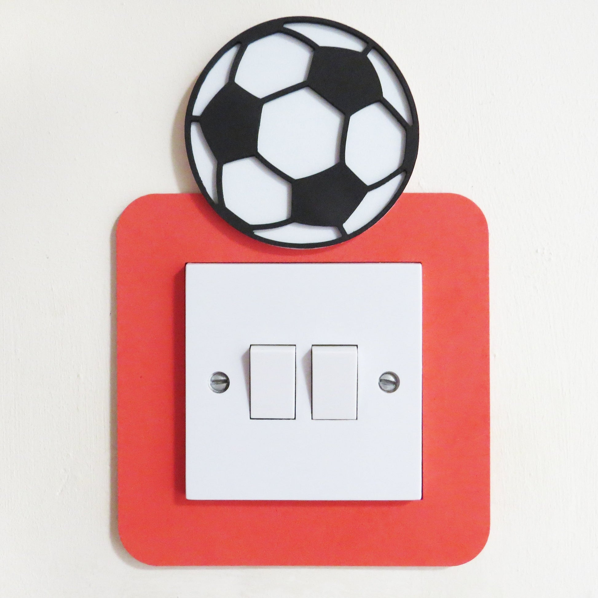 Red craft foam light switch surround designed with a black and white football