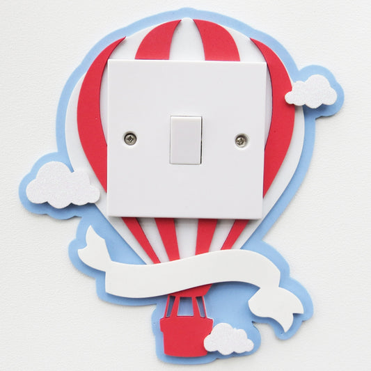 Hot air ballon shaped light switch surround with clouds andbanner.