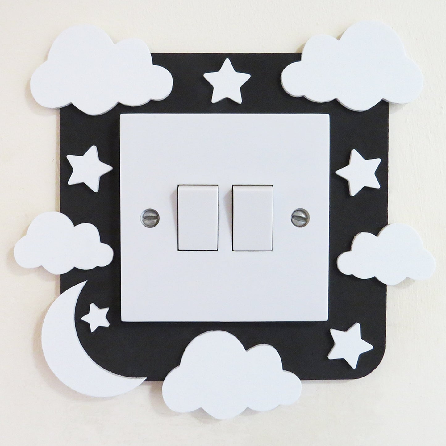 Black craft foam light switch surround designed with clouds, stars  and a moon.