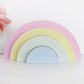 Childrens nursery rainbow shelf stacker painted in pastel colours.