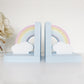 A pair of rainbow shaped nursery wooden bookends painted in pastel colours.